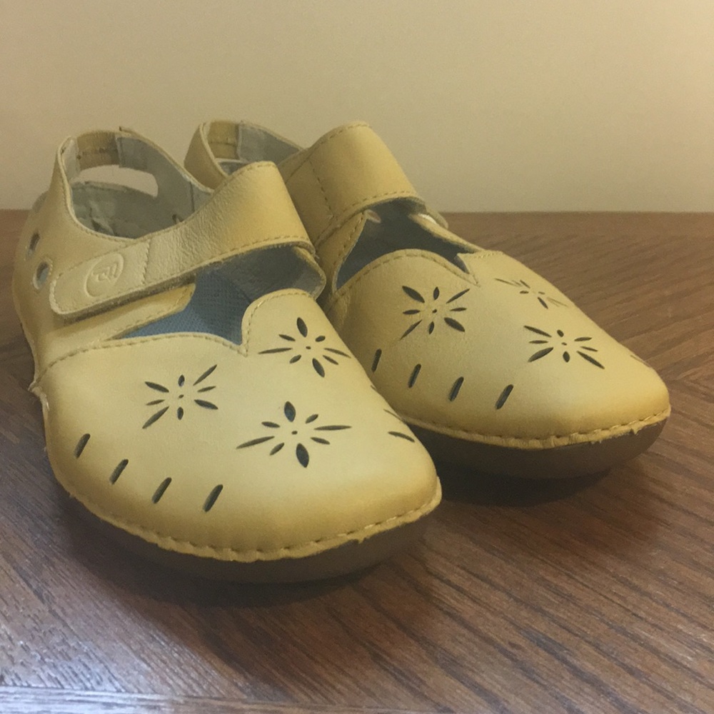 Pair of yellow Propét shoes.